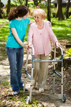 a woman helping another woman with a walker