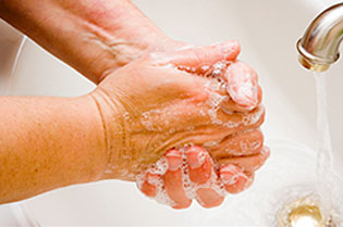 A person washes their hands.