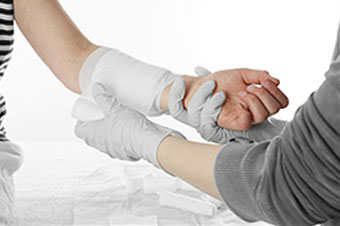 A person wraps a patient's arm.