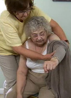 woman assisting another woman dressing