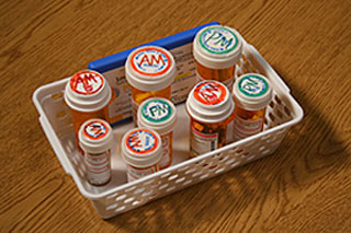 A group of prescription bottles sit in a container