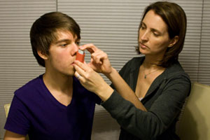 a photo of a person using an inhaler