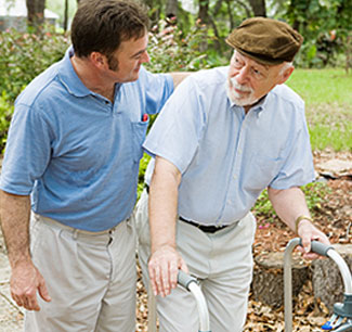 a man walks beside a man with a walker