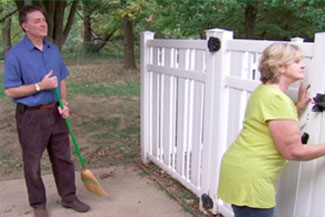 woman looks out the gate