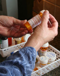 person examining medication bottle