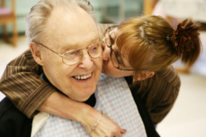 a woman kissing a man on the cheek